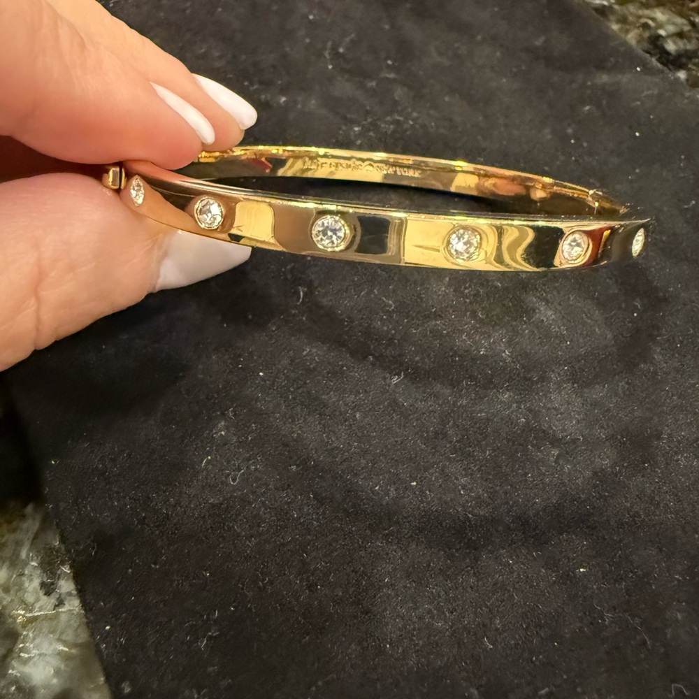 Kate Spade Love click bracelet. Gold tone. Diamond-like stones.